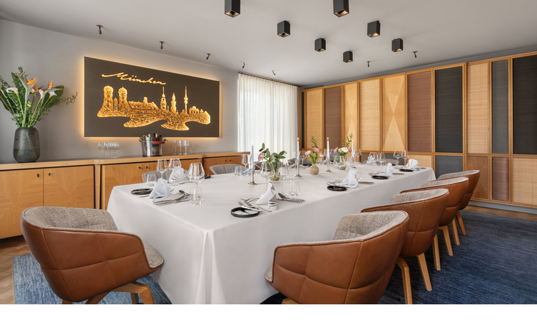 A dining table laid with a white tablecloth in a private room.