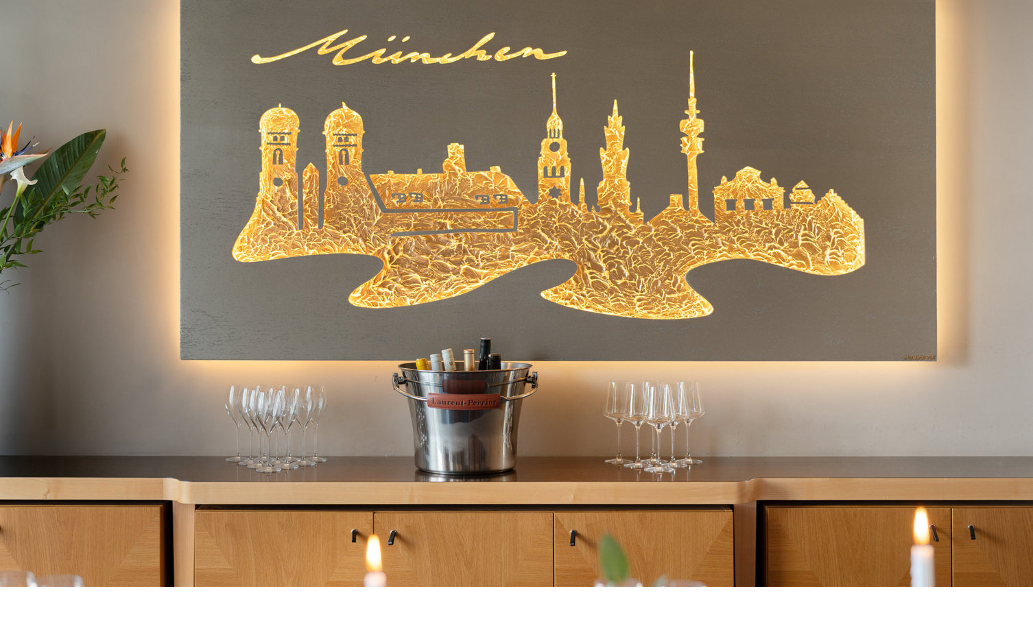 A metal artwork depicting the Munich skyline on the wall.