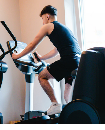 A man works out on an exercise bike in the fitness room of the LOUIS Hotel Munich.